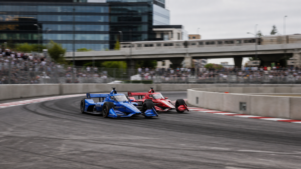 IndyCar Markham street circuit cars racing side by side through a wide hairpin